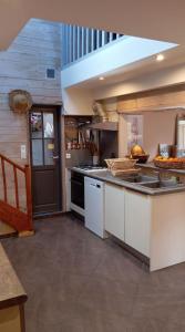 een keuken met een spoelbak en een aanrechtblad bij Les bananiers in Bergerac