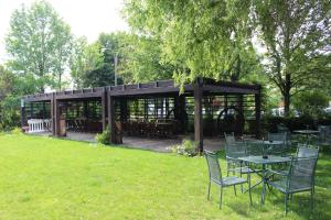 a gazebo with tables and chairs in the grass at Da Mariuccia in Robecchetto con Induno