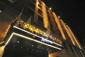 a sign on the side of a building with lights at Radisson Blu GHR Rome in Rome