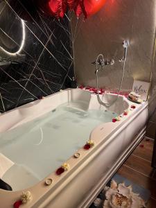 a bath tub with flowers on the side of it at Dyson Ville in Dehradun