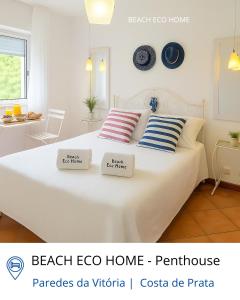 a bedroom with a bed with two pillows on it at BEACH ECO HOME Penthouse in Senhora da Vitória