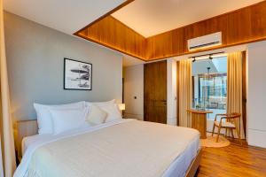 a bedroom with a white bed and a window at NEW! Luxury Modern 3BR Villa Kesatu in Canggu in Canggu +44 photos