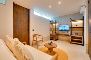 a living room with a couch and a tv at NEW! Luxury Modern 3BR Villa Kesatu in Canggu in Canggu