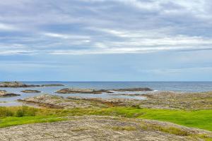 a view of the ocean with rocks and the water at Hus med panoramutsikt i Bud in Bud +8 photos