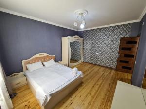 a bedroom with a bed and a blue wall at QQS villa with swimming pool in Gabala +16 photos