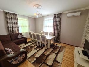 a living room with a table and a couch at QQS villa with swimming pool in Gabala