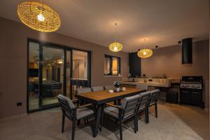 a kitchen and dining room with a table and chairs at Villa Dujma in Kostrena