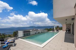 a swimming pool on top of a building with a view at Villa Dujma in Kostrena +42 photos