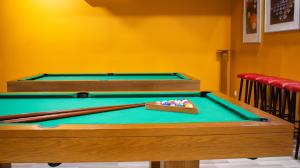 a pool table with a box of balls on it at Mobility Friends Hostel in Barcelos +24 photos
