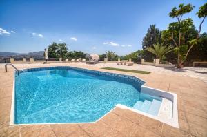 a swimming pool with blue water in a yard at Letymvou Terrace in Letimbou