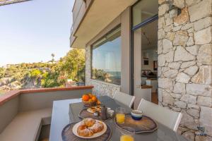 a table with two plates of food on a balcony at Vero Sicily - Villa Acqua Chiara in Bagheria