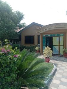 a house with plants in front of it at Rising Sun Hotel in Mwanza +9 photos