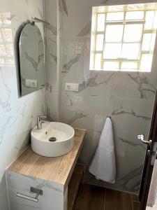 a bathroom with a sink and a mirror at Nicks apartments in Ierissos +14 photos