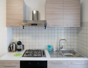 a kitchen with a stove and a sink at Casa Maria in Chioggia +8 photos