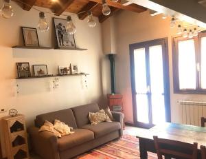 a living room with a couch and a table at La casa rossa in Costa Volpino +11 photos