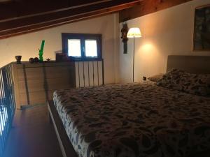 a bedroom with a bed and a window at La casa rossa in Costa Volpino