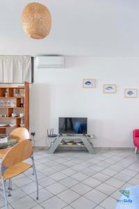 a living room with a table and a fireplace at Vero Sicily - Villa Acqua Chiara in Bagheria