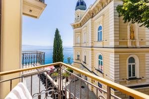 an apartment balcony with a view of the ocean at Hotel Savoy in Opatija