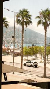 a car parked in a parking lot with a ferris wheel at Rio Boutique Hotel Vlore in Vlorë