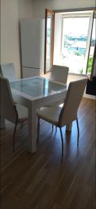 a dining room table with two chairs and a glass top at Charmant appartement de village in Roquebrune-sur-Argens +11 photos