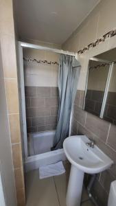 a bathroom with a sink and a toilet and a tub at Anora in Marseille