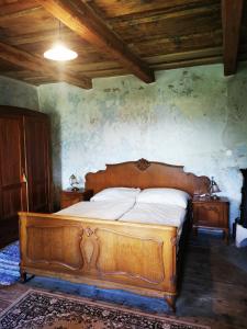 a bedroom with a large wooden bed in a room at Ubytovanie Domček Paradajz in Banská Štiavnica +16 photos