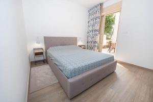 a bedroom with a bed in a room with a window at Apartment Marta in Ljuta