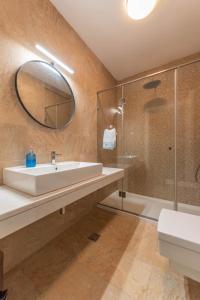 a bathroom with a sink and a shower and a mirror at Apartment Marta in Ljuta