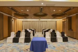 a conference room with a blue table and chairs at Pride Hotel Pune in Pune +64 photos