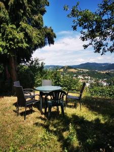 a table and chairs sitting on top of a hill at Ubytovanie Domček Paradajz in Banská Štiavnica