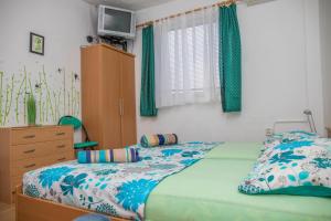 a bedroom with a bed and a dresser at Apartman Katarina in Dramalj +33 photos