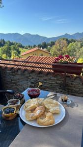a table with a plate of pastries on it at Hotel Smilen in Smolyan