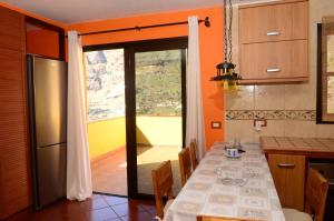 a kitchen with a table and a large window at Casa La Erita in Valle Gran Rey