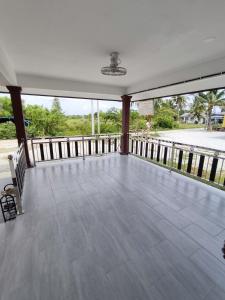 a large screened porch with a view of the water at D Padang Homestay Manir kuala Terengganu in Kuala Terengganu