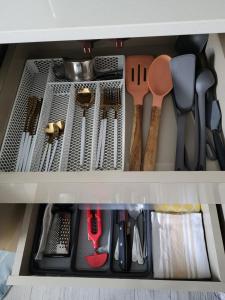 a drawer filled with lots of kitchen utensils at Cozy Studio in TCI in Providenciales +15 photos