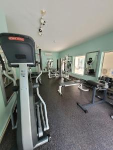 a gym with treadmills and machines in a room at Cozy Studio in TCI in Providenciales
