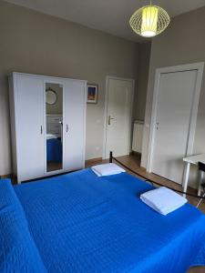 a bedroom with a blue bed with a mirror at B&B Camposauro in Vitulano