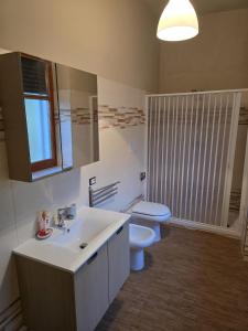 a bathroom with a sink and a toilet and a mirror at B&B Camposauro in Vitulano