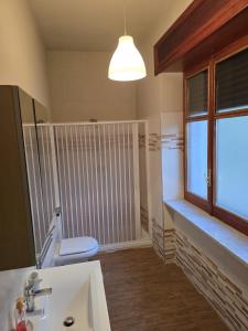 a bathroom with a toilet and a sink and a window at B&B Camposauro in Vitulano