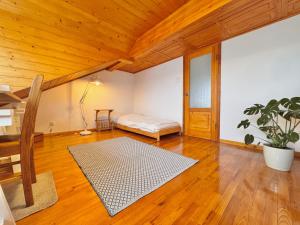 a living room with a bed and a wooden ceiling at Willa Tradycja 2 in Gdańsk