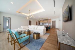 a living room with a white couch and a table at The Exclusive Sky D1 豪华4卧室海景别墅 私人12m无边海景泳池 每日清洁 in Kamala Beach