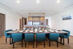 a dining room with a table and blue chairs at The Exclusive Sky D1 豪华4卧室海景别墅 私人12m无边海景泳池 每日清洁 in Kamala Beach +70 photos