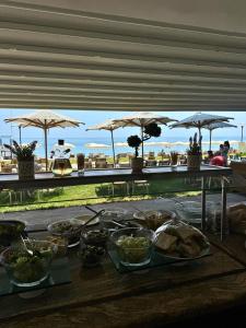 a table with food on it with umbrellas at HVD Viva Club Ultra All Inclusive - Private Beach & Free Parking in Golden Sands