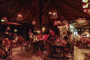 a group of people sitting at tables in a restaurant at Sa Sa Lao in Luang Prabang