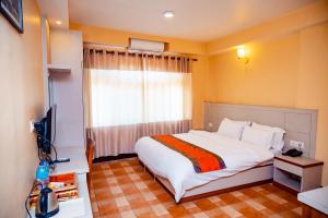 Postel nebo postele na pokoji v ubytování Tashi Pal hotel