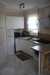 a kitchen with white cabinets and a stove top oven at Studio a Bois-Bernard 62320 in Bois-Bernard +6 photos