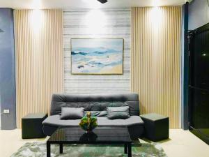 a living room with a couch and a table at Sea Bed's Inn in Glan