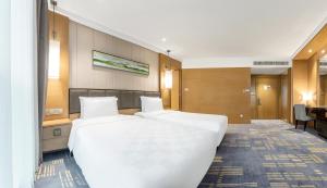 Voodi või voodid majutusasutuse Lyhn International Hotel Chengdu Taikoo Li toas
