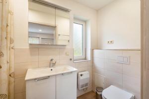 a bathroom with a sink and a toilet at Bungalow 91 in Stelzendorf +15 photos