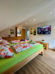 a large bedroom with two beds and a flat screen tv at FeWo Wipperhausen in Moos
